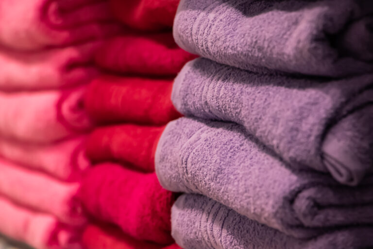 A stack of multi-colored bath towels close-up. Spa accessories for health care.